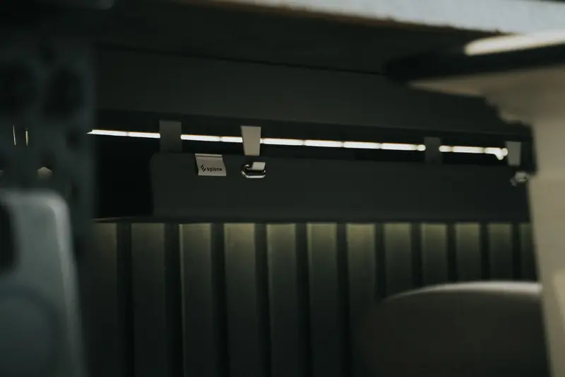 Close-up view of sleek under desk cable management in an office setting, enhancing workspace organization