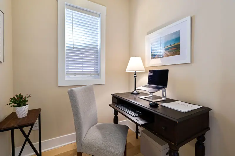 A tidy home office space with a wooden desk, laptop, and ambient lighting. Perfect for remote work